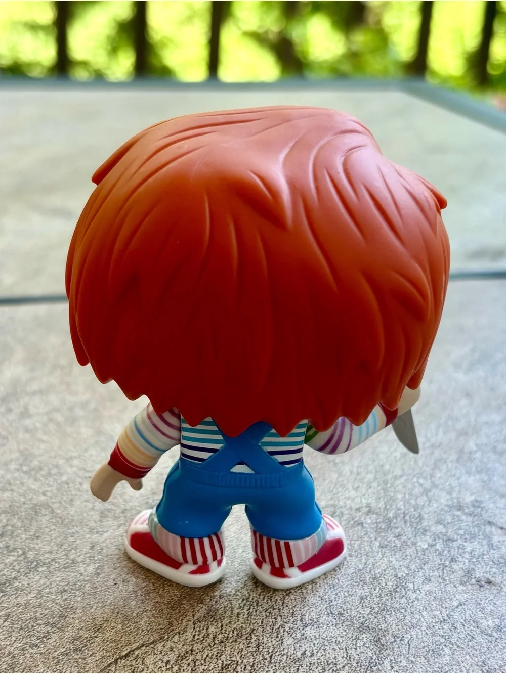Funko Orange-Haired Chucky Figure in Blue Overalls with Multicolor Stripes